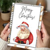A spiral-bound book with a festive Christmas greeting and an illustration of a bearded man in a Santa hat.