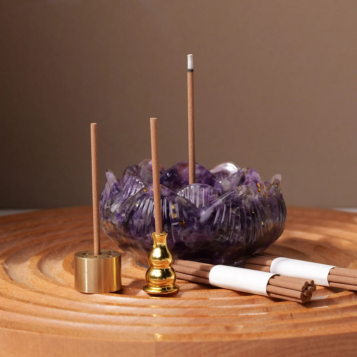 A set of natural crystal droppers and candles displayed on a wooden surface.