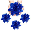 Hand holding a large blue glitter artificial poinsettia flower for Christmas décor