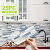 A hand holds a stack of marble pattern 3D effect waterproof tile stickers against a white cabinet and backsplash.