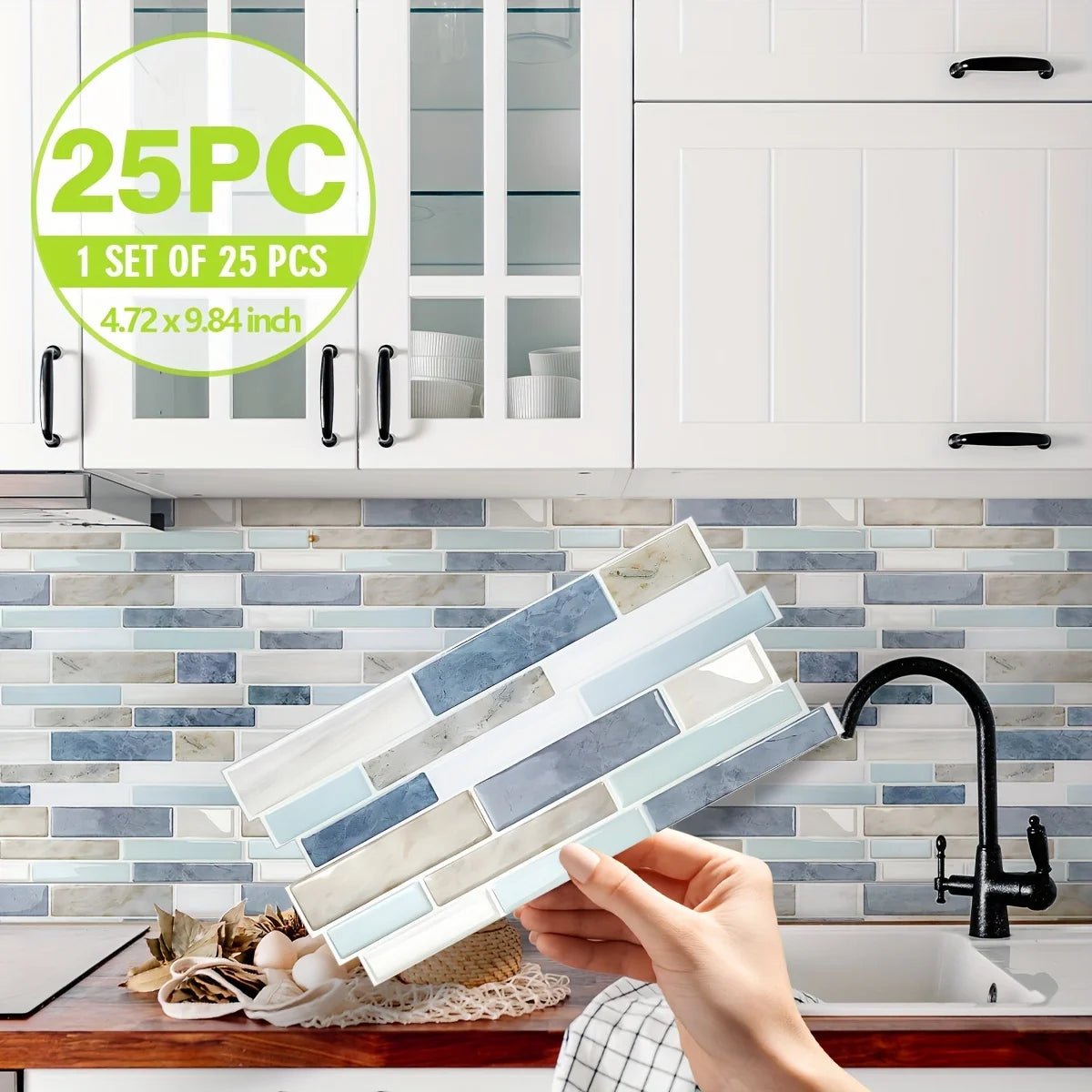 A hand holds a stack of marble pattern 3D effect waterproof tile stickers against a white cabinet and backsplash.