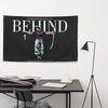 A black flag featuring white text that reads Behind with a silhouette of a person.