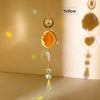 A yellow natural agate sun catcher crystal decor hanging from a gold chain.