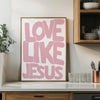Pink text wall art print with the words LOVE LIKE JESUS on a white background framed in wood