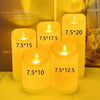 A collection of yellow LED candles with flickering flames displayed on a table.
