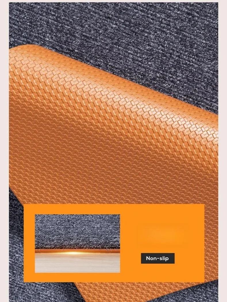 Close-up view of orange artificial grass carpet texture against a gray background.