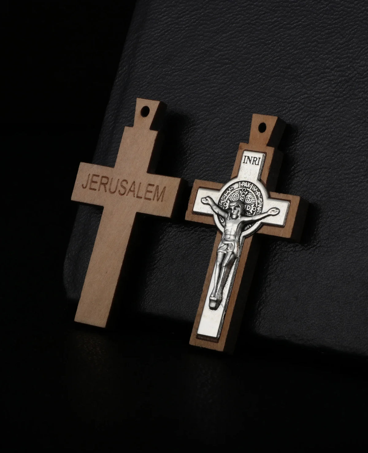 A wooden crucifix pendant with the word JERUSALEM engraved on the cross.
