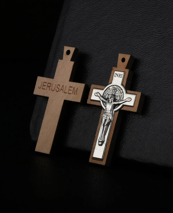 A wooden crucifix pendant with the word JERUSALEM engraved on the cross.