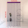 A long, purple beaded string curtain hangs vertically in a bright room.