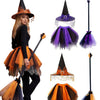 A woman modeling a Halloween witch costume set including a pointed hat, purple tulle skirt, and a black broomstick.