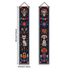 A vertical banner featuring a Mexican skull and floral motifs for a Day of the Dead theme.