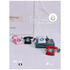 A vintage rotary desk phone miniature decor in pink, black, and red is displayed on a white surface.