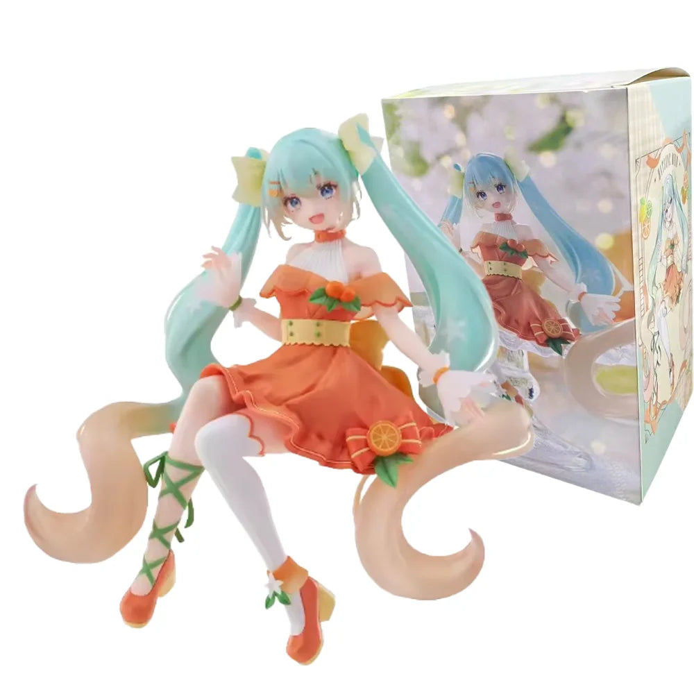 A PVC collectible figurine of Hatsune Miku in an orange dress with light blue hair and a box.