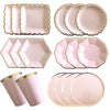 A set of gold and pink disposable party tableware including plates, cups, napkins, and straws.