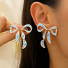 Gold-toned bow stud earrings featuring blue and white porcelain design