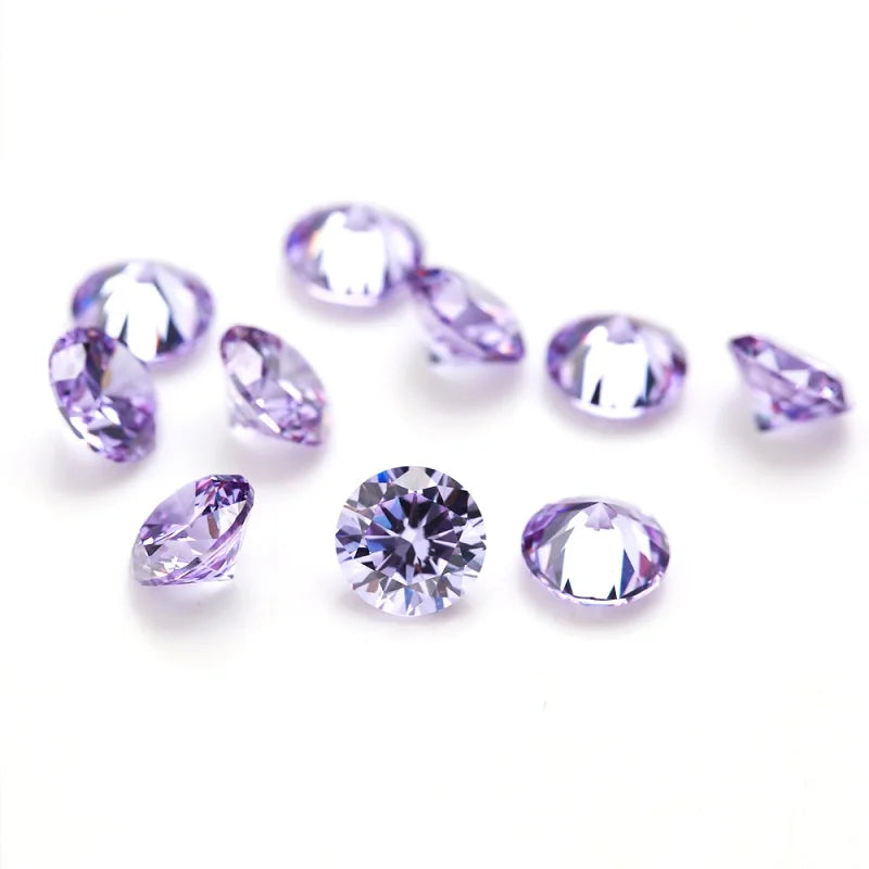 A collection of loose, multi-size round and oval purple cubic zirconia stones for jewelry making.