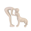 A light beige sculpture depicting a human and a dog embracing.