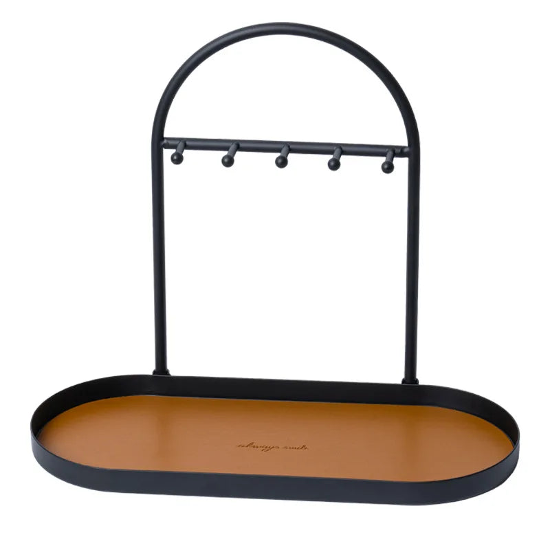 Black wrought iron desk organizer rack with a leather tray for holding pens and supplies