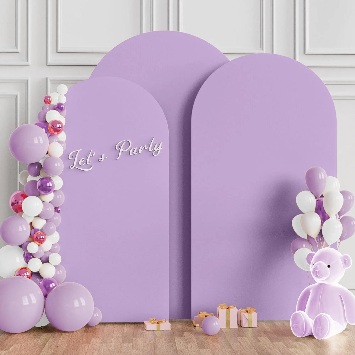 A purple spandex fitted arch backdrop decorated with balloons and a 'Let's Party' sign.