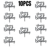A collection of black acrylic cake topper letters spelling out Happy Birthday, repeated multiple times.