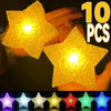 Ten yellow LED star lights held in a hand, showing various colors.