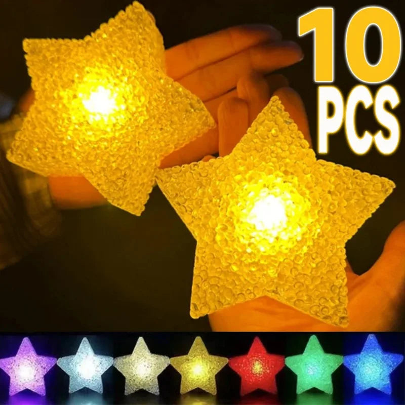 Ten yellow LED star lights held in a hand, showing various colors.
