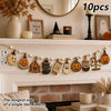 A string of vintage wooden Halloween decorations featuring pumpkins, ghosts, and moons displayed on a fireplace mantel.