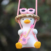 A cute pink anime duck ornament wearing a straw hat and sunglasses, suspended by a pink string.