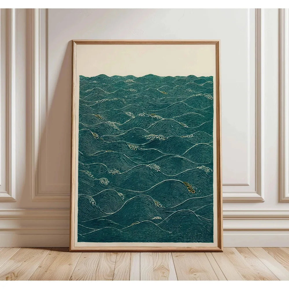 A framed canvas print featuring deep teal water texture with gold accents, displayed on a light wooden floor.