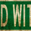 Vintage green metal sign with the text WICKED WITCH WAY on a distressed background.