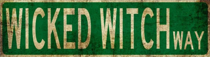 Vintage green metal sign with the text WICKED WITCH WAY on a distressed background.