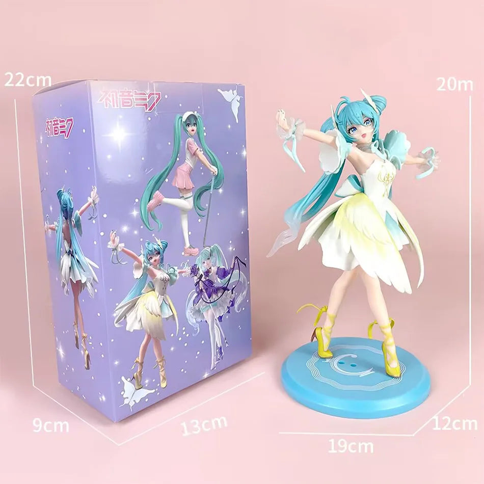 A PVC figure of Hatsune Miku in a ballet pose, featuring light blue hair and white and yellow costume, displayed next to its 