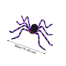 A light-up, furry Halloween spider decoration with purple glow.