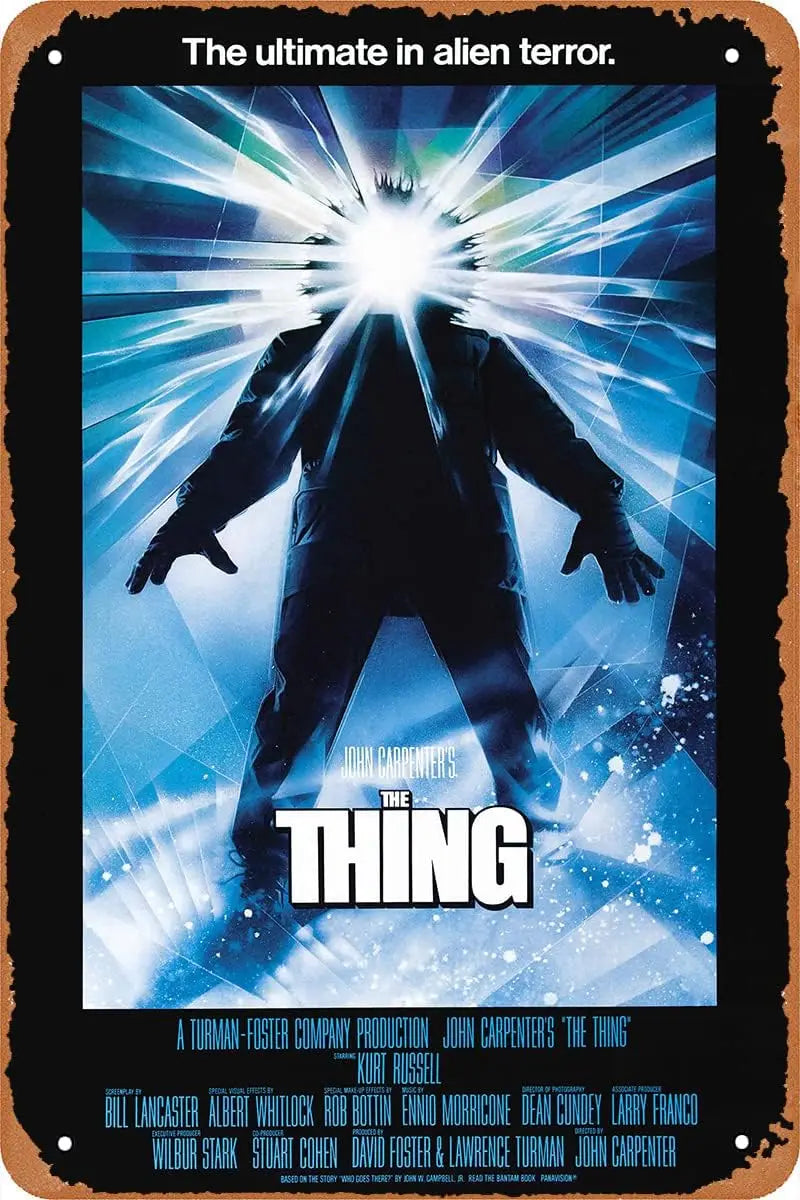 A vintage metal tin sign featuring a poster of the movie The Thing with John Carpenter's title.