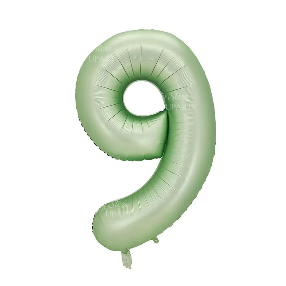 A large, light green foil number balloon shaped like the numeral 9.