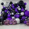 A dense arrangement of dark purple and silver latex balloons for party decor