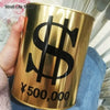 A hand holds a large gold-colored metal piggy bank with a black dollar sign and the text ¥500,000 printed on it.