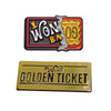A gold ticket lapel pin featuring the text WONBA and a gold coin design.