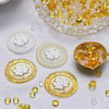 A collection of transparent wax sealing beads in yellow and amber tones, displayed in a glass bowl and on white discs.