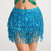 A bright blue fringed skirt adorned with sequins and tassels worn by a model.