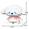 A white and pink animal-shaped building block model kit with black eyes and blue accents.