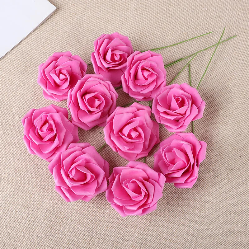 A cluster of twenty vibrant pink foam rose blooms arranged on a beige fabric background.