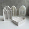 White silicone molds shaped like gothic church windows for crafting resin and plaster