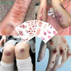 A collection of realistic bruise and scar temporary tattoos shown on skin and paper sheets.