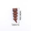 A small, brown 3D printed cartoon bear figurine with a cute expression.