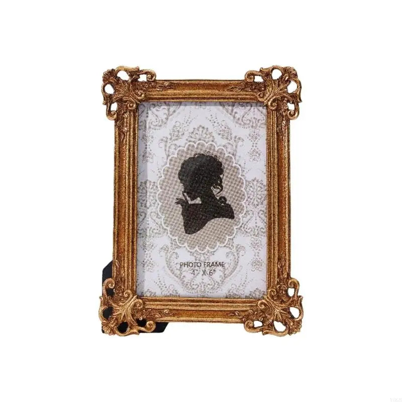 An elegant gold resin photo frame with a vintage European design, featuring a white textured background.