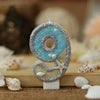 Glitter number 9 cake topper with a starfish design in blue and silver glitter