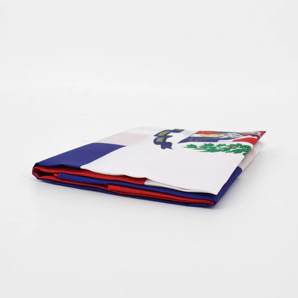 Folded Dominican Republic flag fabric showing blue, white, and red colors.
