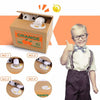 A child is holding an orange cardboard box containing an interactive coin bank with an animal design for kids.