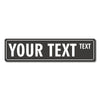 A rectangular black metal street sign with the text YOUR TEXT and a smaller word TEXT.